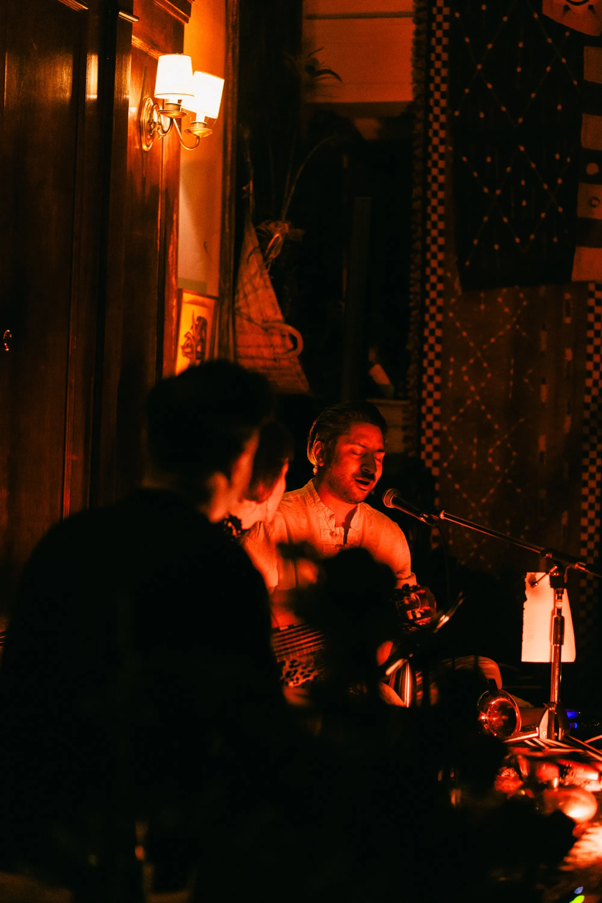 Global artist Benjamin Urbaez and DJ Dreeemy live performance atmosphere with warm stage lighting in Harlem NYC