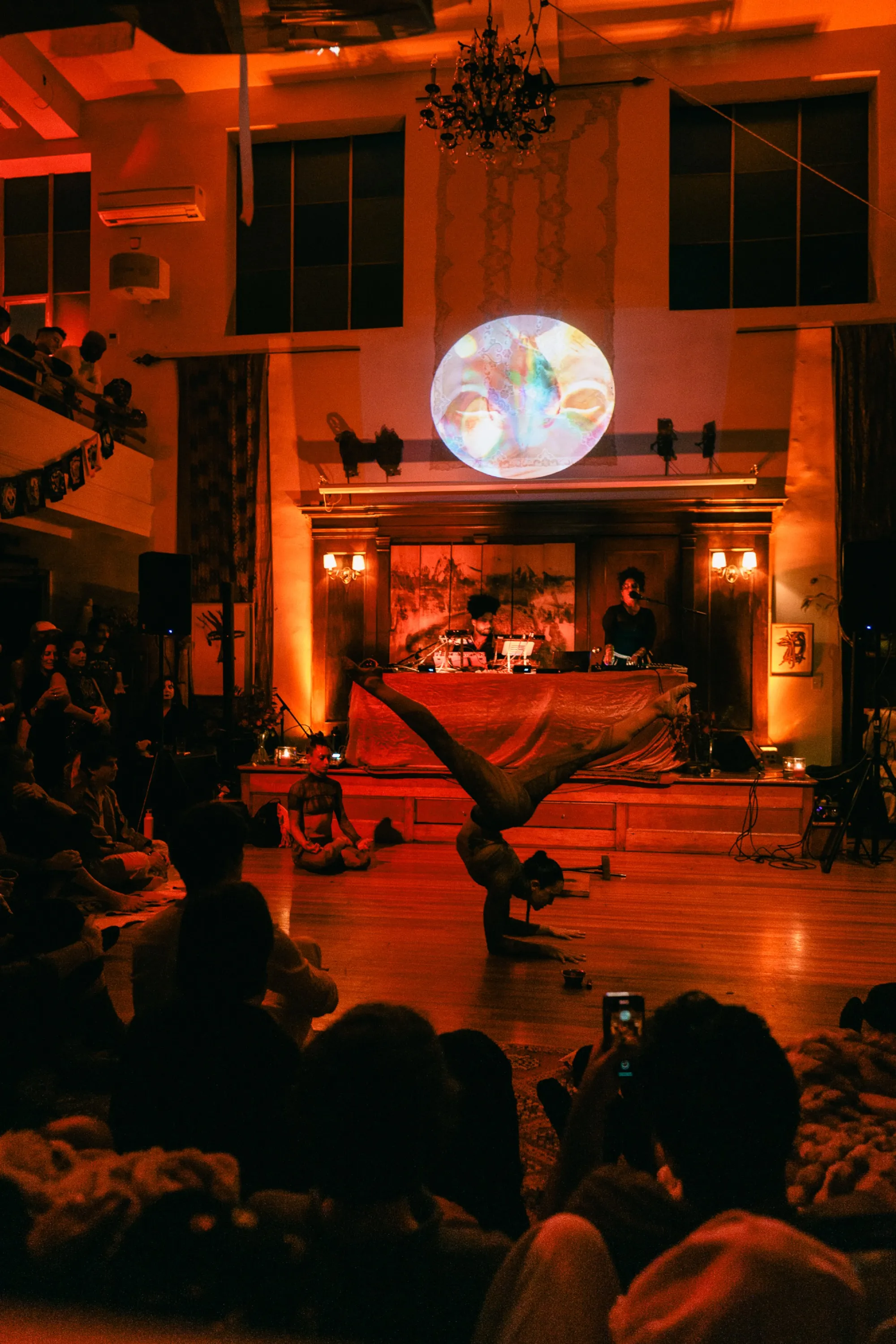 Global artist Benjamin Urbaez and DJ Dreeemy performing with projected art visuals overhead at Harlem venue