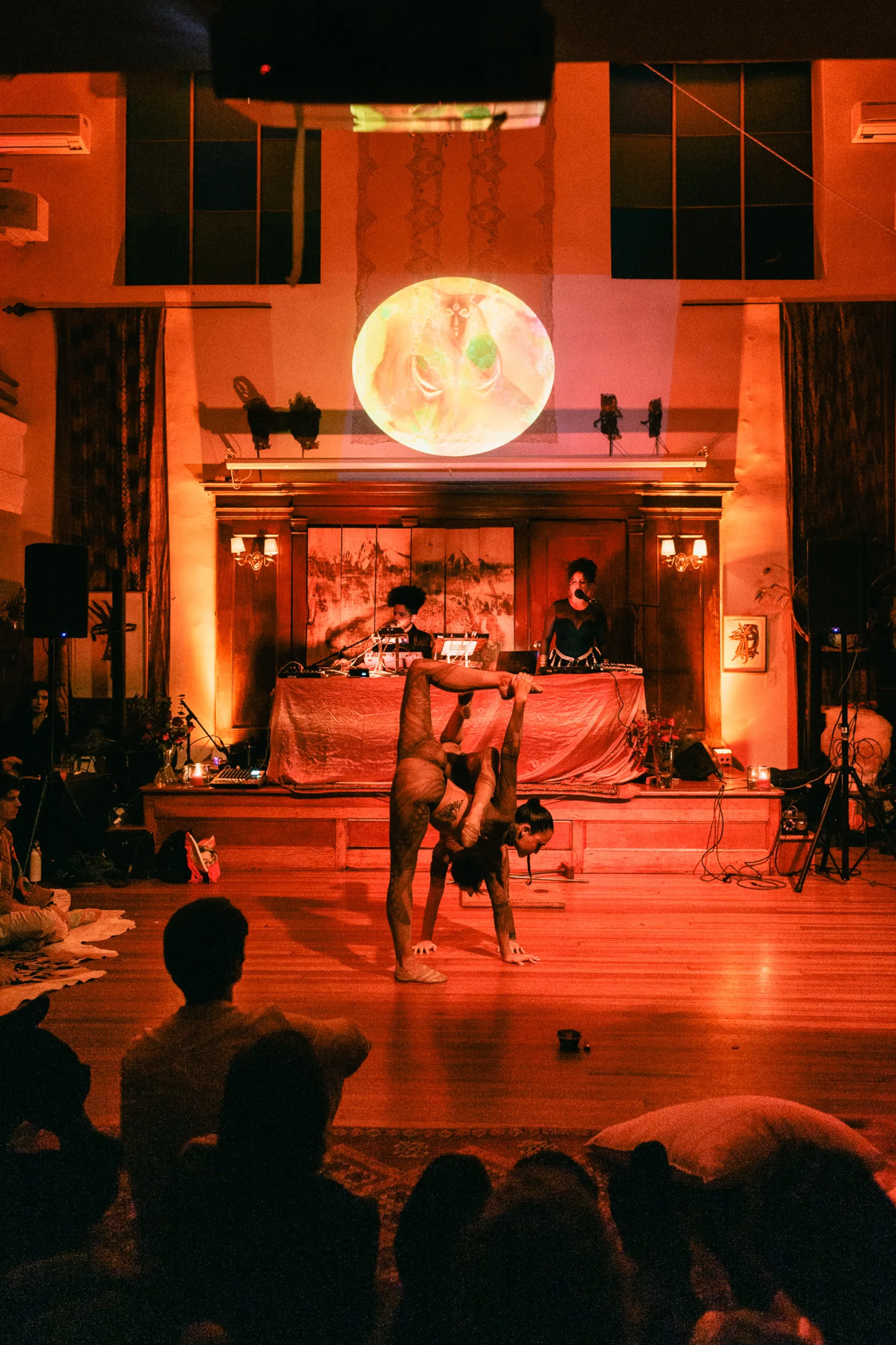 Global artist Benjamin Urbaez and DJ Dreeemy dancers performing during live show at Viewcy Harlem with amber stage lighting