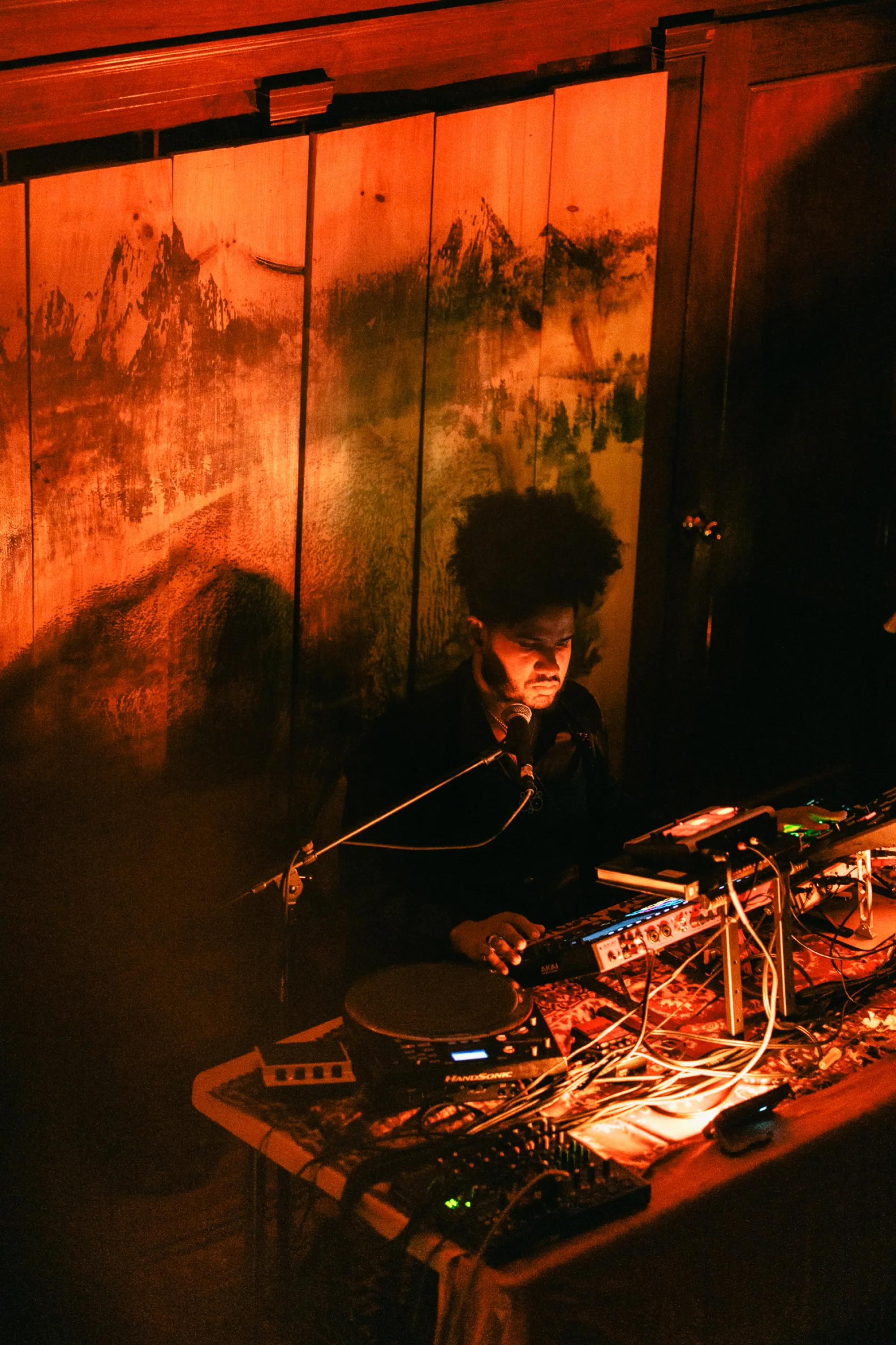 Global artist Benjamin Urbaez and DJ Dreeemy live at Love Is Everything event with warm amber stage lighting